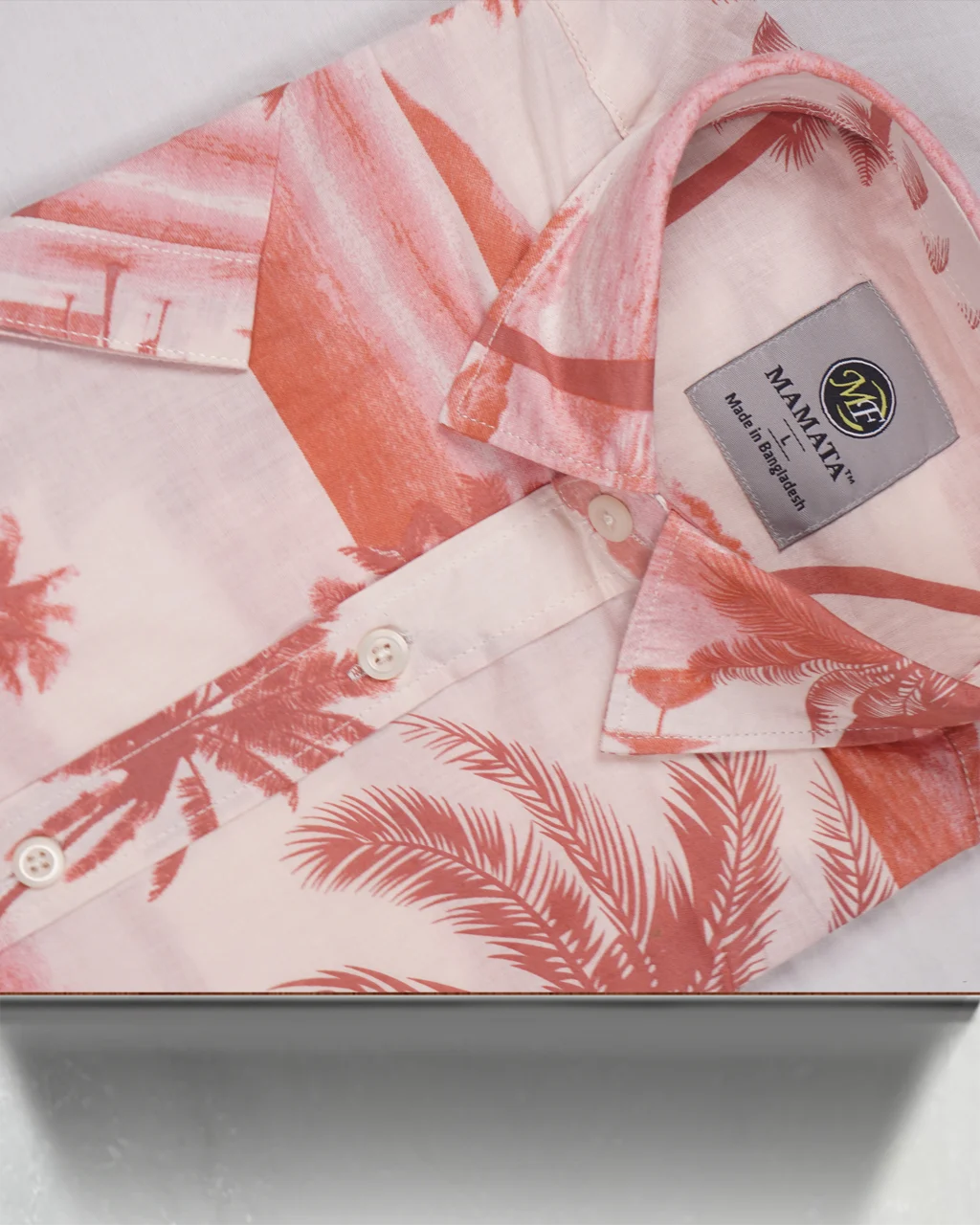 This men's printed shirt with short sleeves features a stunning sunset/beach landscape design. The fabric showcases an impactful all-over palm tree print and large coconut tree silhouettes, making it a true men's Hawaiian print shirt.